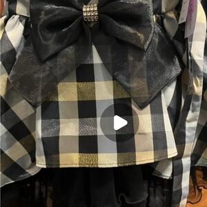 New Toddler girl dress. It has black, gold, and silver with a tie in the back.